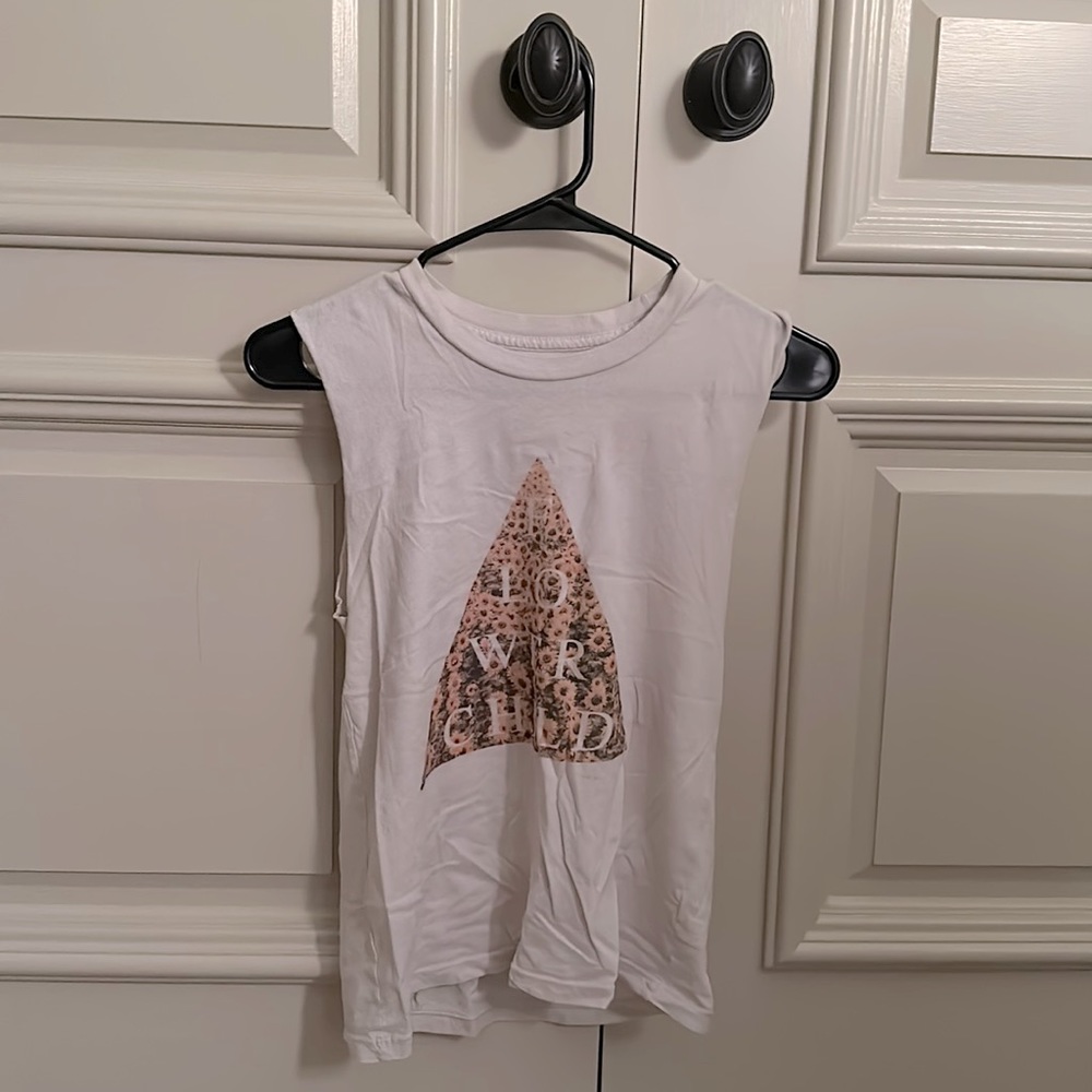 Sleeveless cream/white shirt with a triangular sunflower field, “FLOWER CHILD”